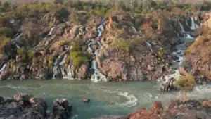 Aerial view of Epupa Falls cascading over rocky terraces on the Kunene River, Kaokoland, Namibia
